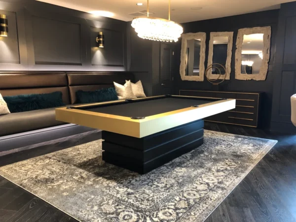 A black and gold Item # CM5081-PT billiard table in a living room.