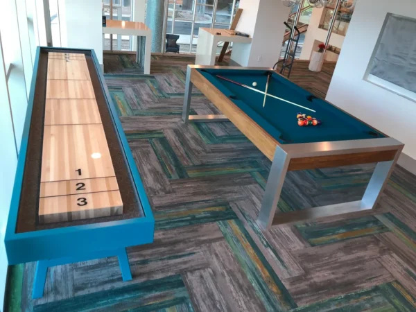 A shuffleboard table (Item # CM5038-PT) and a pool table in an office.