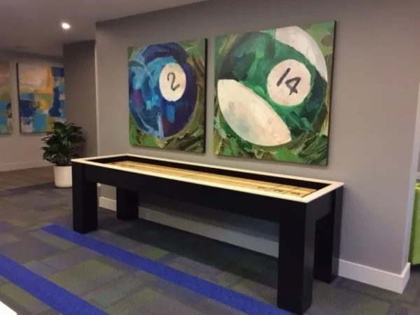 Shuffleboard table (Item # GW6064-SH) in an office with paintings on the wall.