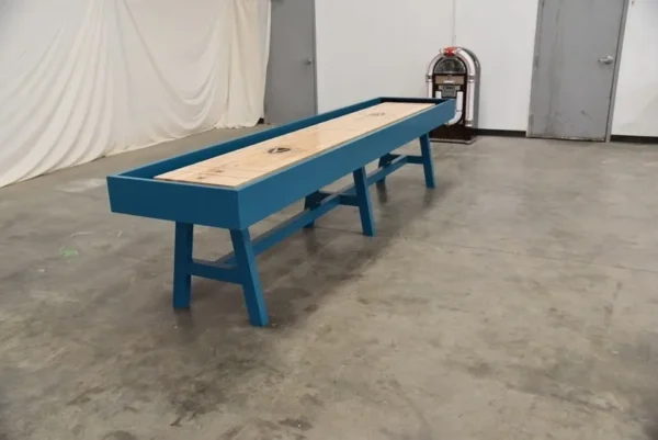 A blue shuffleboard table (Item # VG6146-SH) in an empty room.