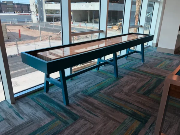 Shuffleboard table Item # CM6028-SH in the lobby of a building.