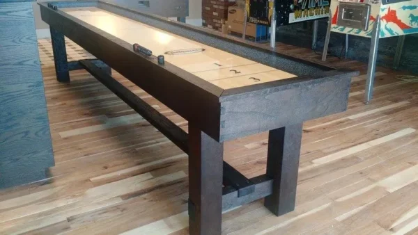 An Item # IM6120--SH shuffle board table in a room.