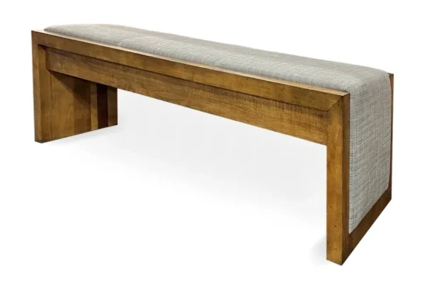 A wooden bench with a grey fabric upholstered seat.