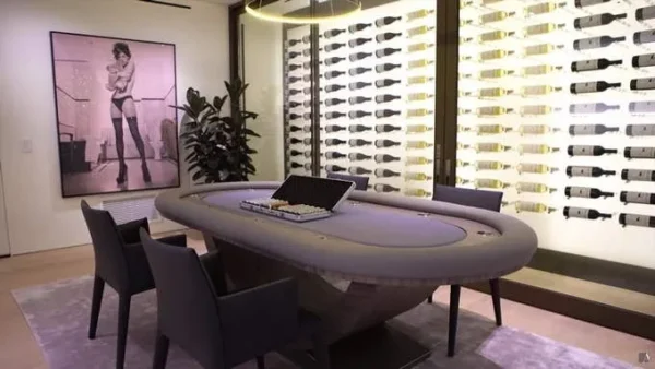 A room with a poker table and chairs.