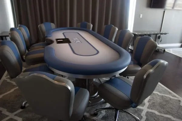 A poker table and chairs in a room.