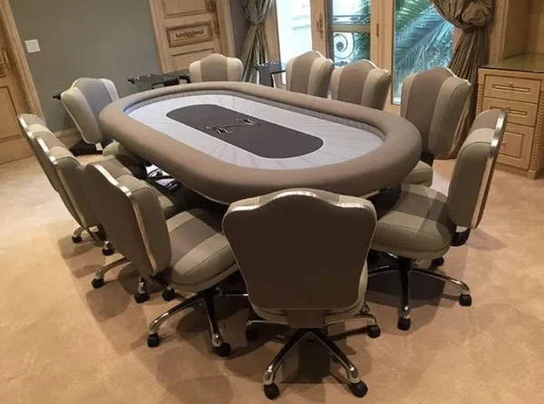 A poker table and chairs in a room.