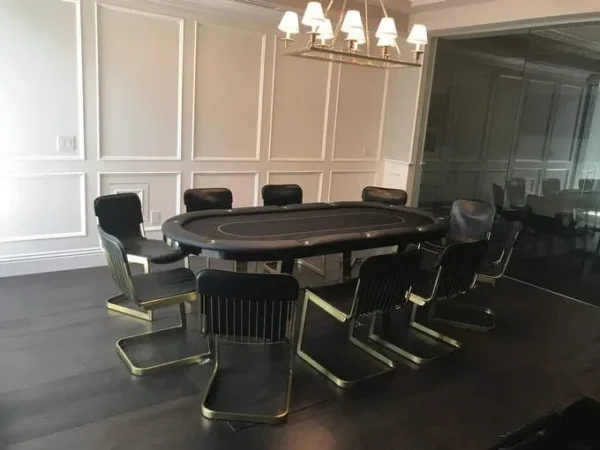 A poker table and chairs in a room.