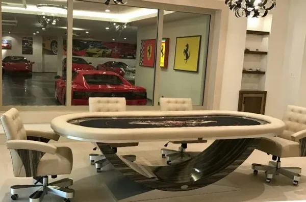 A poker table in a room with a lot of cars.
