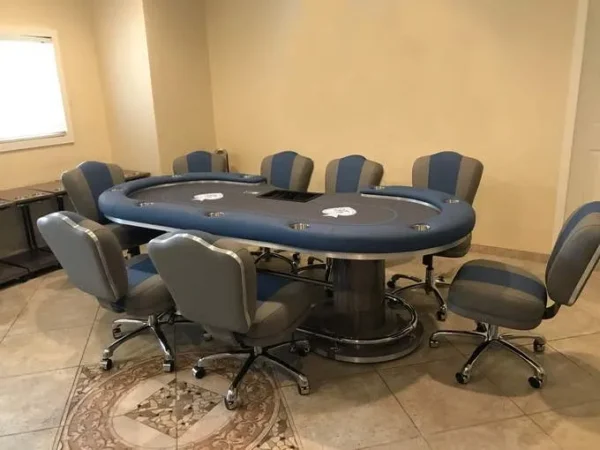 A poker table and chairs in a room.