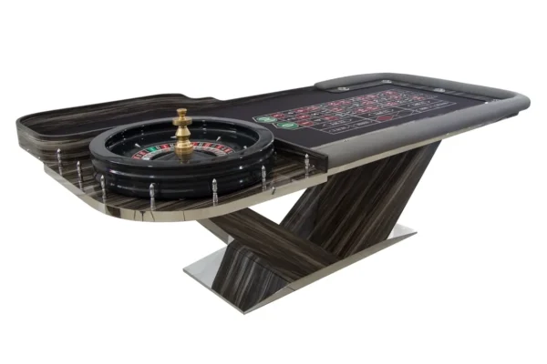 A casino table with a roule wheel on top.