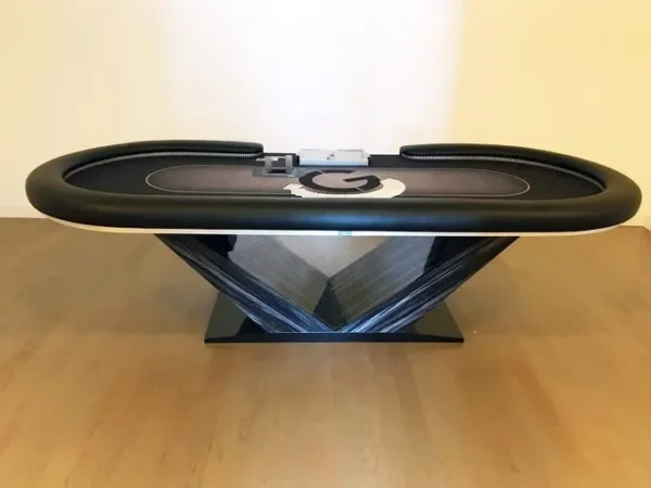 A poker table with a black leather top.