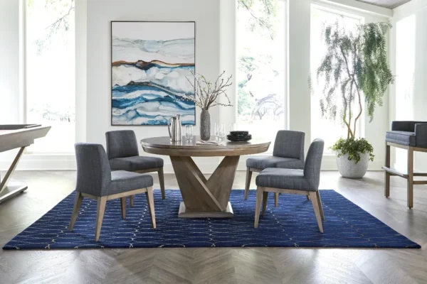 A modern dining room with a blue rug and chairs.