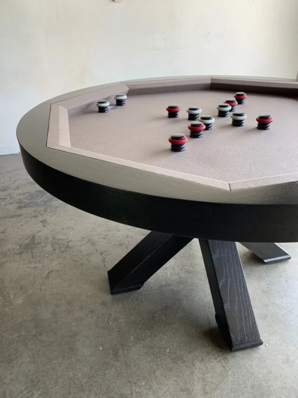 A pool table in a room with a set of billiard balls.
