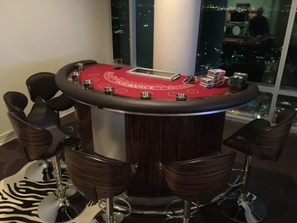A bar with a poker table and zebra rugs.