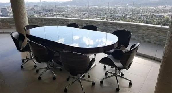 A conference table with chairs and a view of the city.