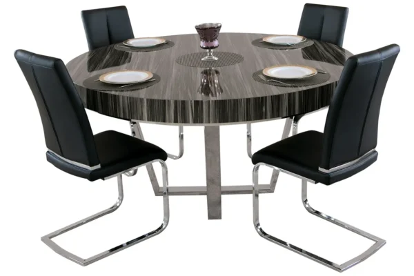 A round dining table with four black chairs.