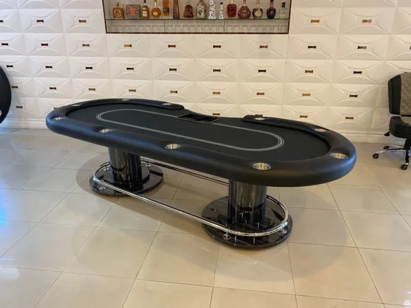 A black poker table in a room.