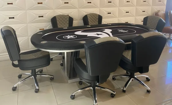 A poker table and chairs in a room.