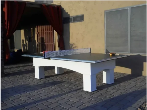 A ping pong table in front of a house.