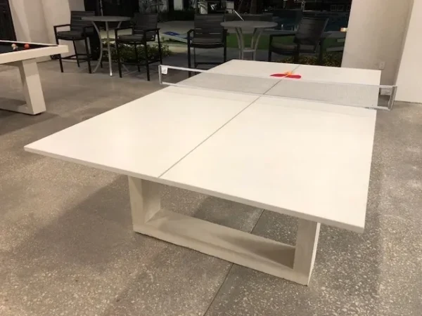 A white ping pong table in a room.