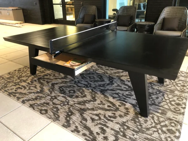 A black ping pong table in a lobby.