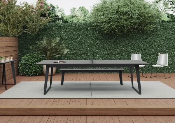 An outdoor table and chairs on a wooden deck.