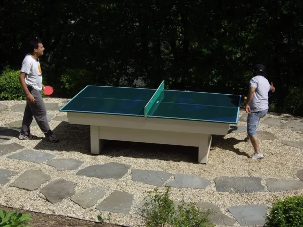 Two men playing table tennis outdoor