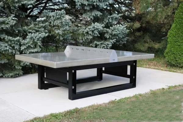 A ping pong table in a backyard.