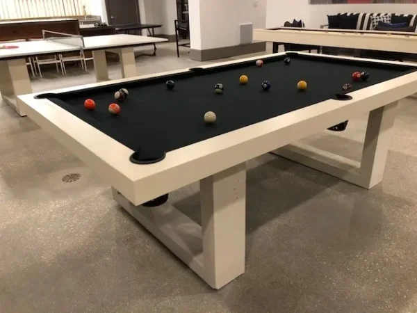 A pool table in a room with a black cloth.