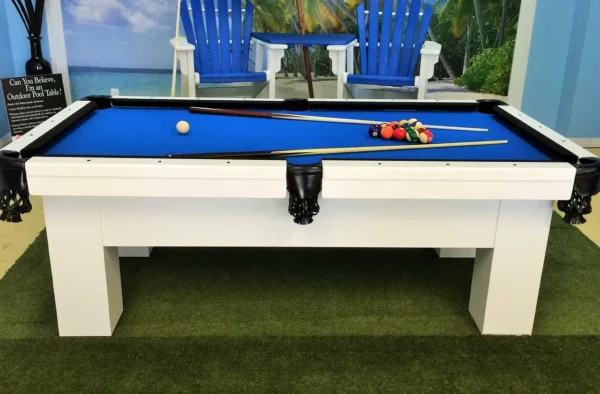 A pool table in front of a lawn chair.