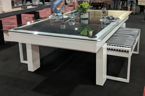 A table with a glass top and a bench.