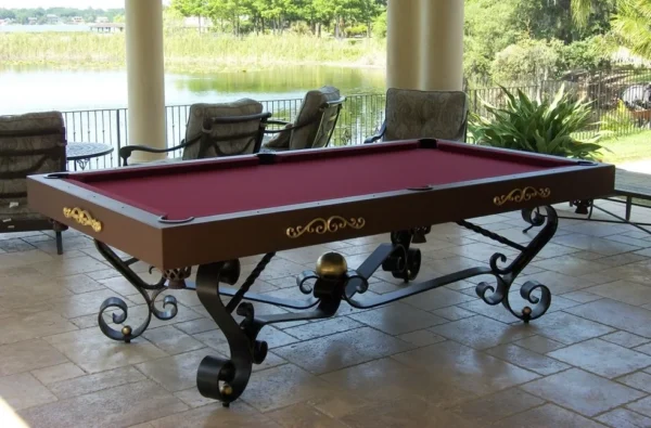 A pool table with a red cloth on a patio.