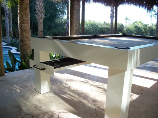 A billiard table with a drawer in the middle.