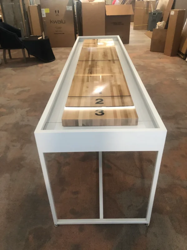 Shuffleboard table in a warehouse.