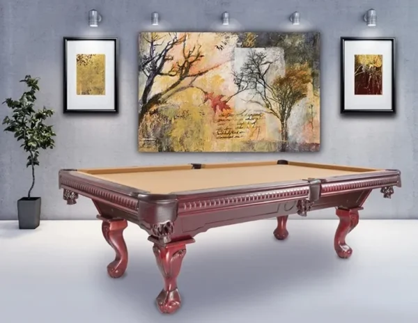 A pool table in a room with paintings on the wall.