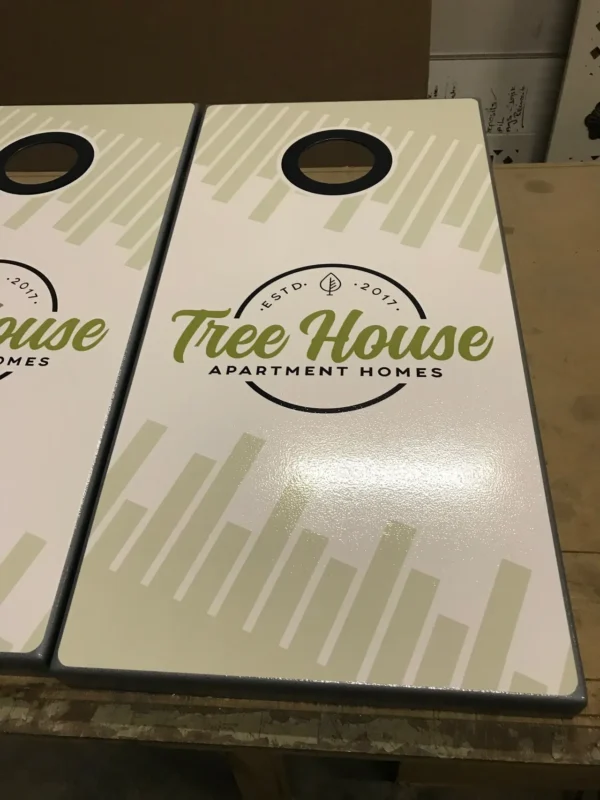 Two cornhole boards with the logo of the tree house.