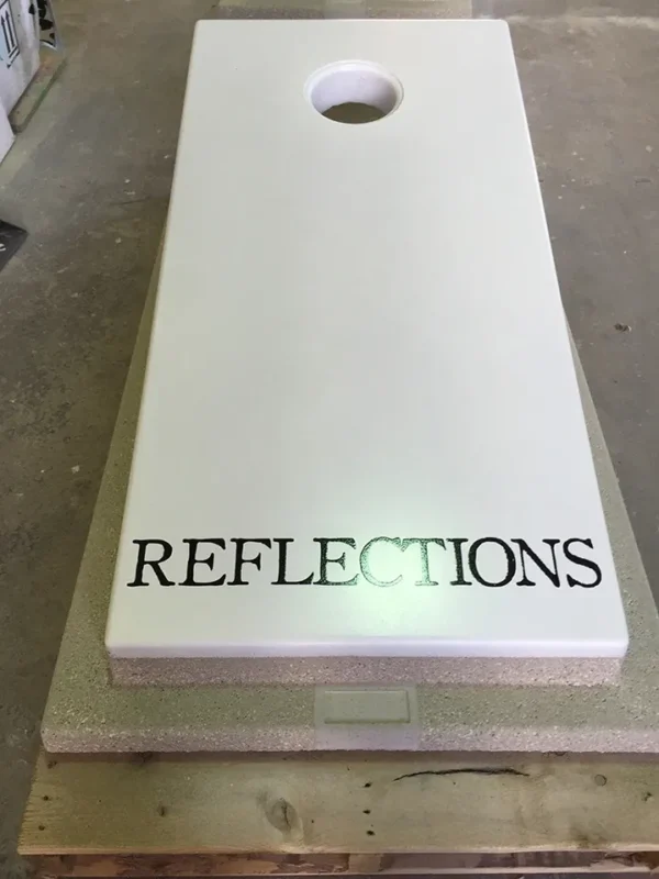 A cornhole board with the word reflections on it.