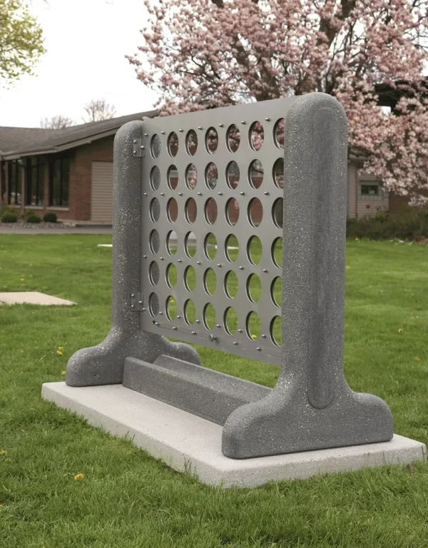 A piece of concrete sitting on a grassy area.