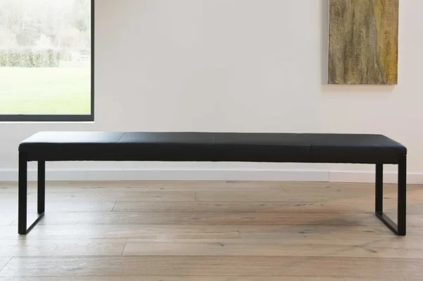 A black leather bench (Item # FS13029-CH) in front of a window.