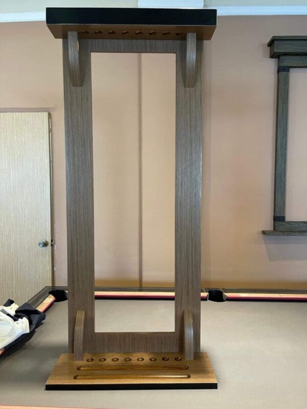 A Item # PH22031-CRW with a rectangular base and a series of round pegs at the top and bottom.