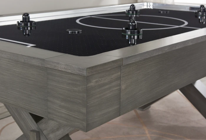 Gray wooden air hockey table corner.