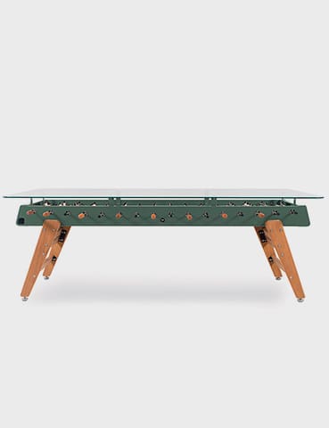 Green foosball table with wooden legs.