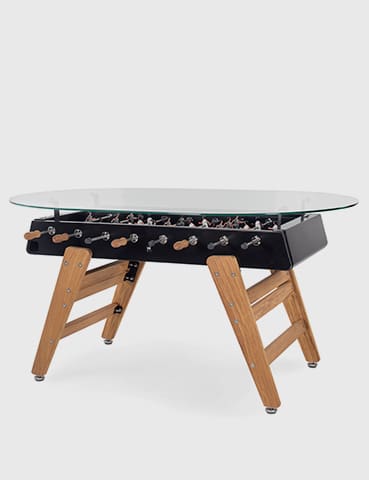 Black and wood foosball table with glass top.