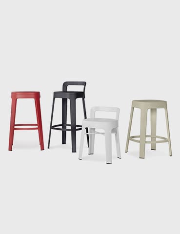 Four colorful metal bar stools.