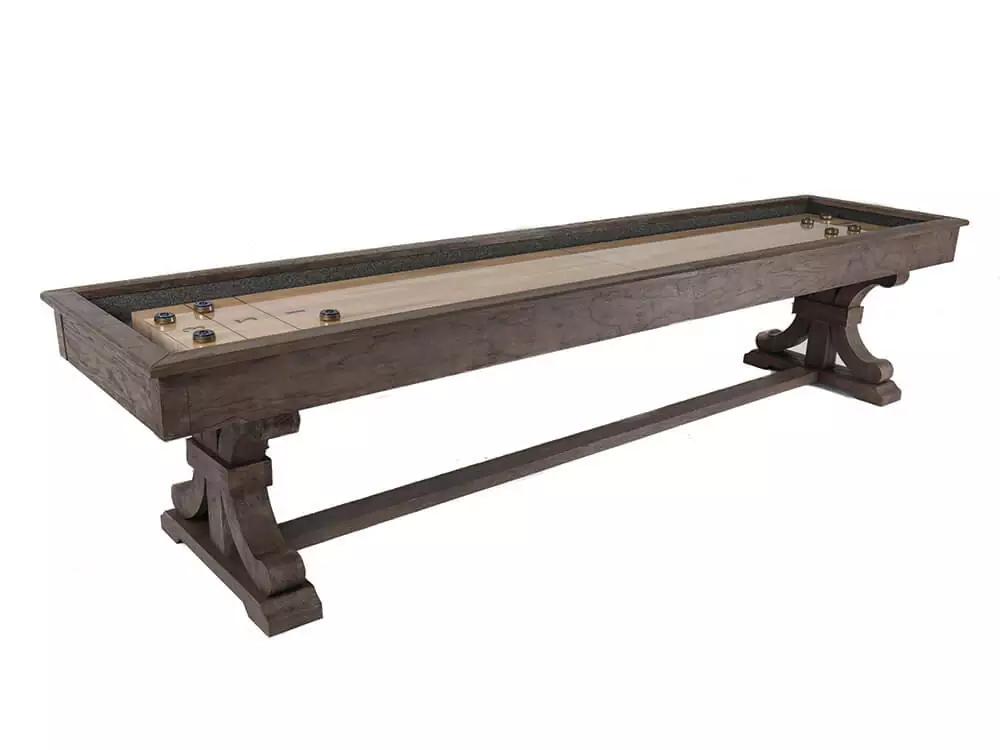 Wooden shuffleboard table with ornate legs.