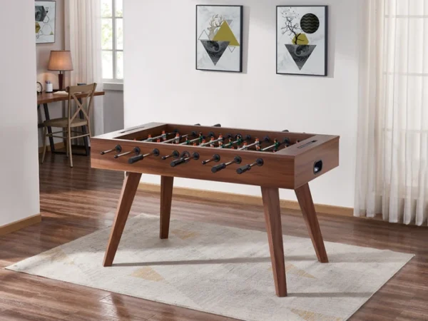 Wooden foosball table in a living room.