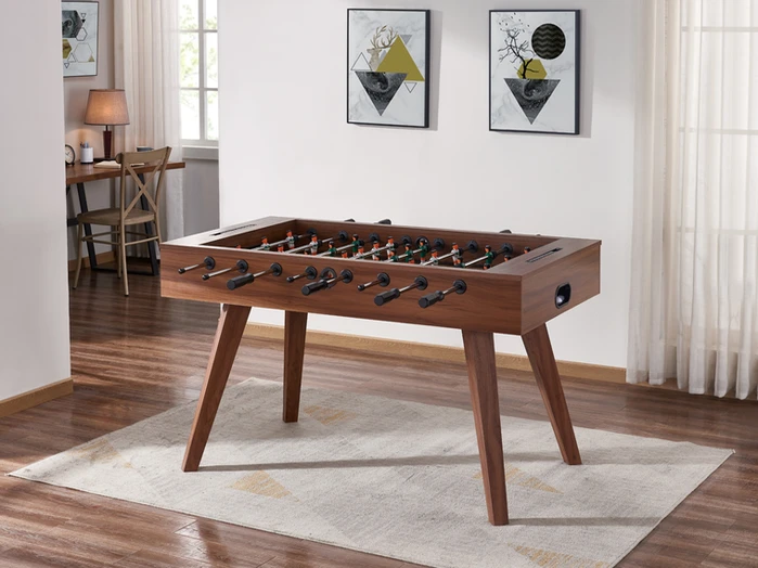 Wooden foosball table in a living room.