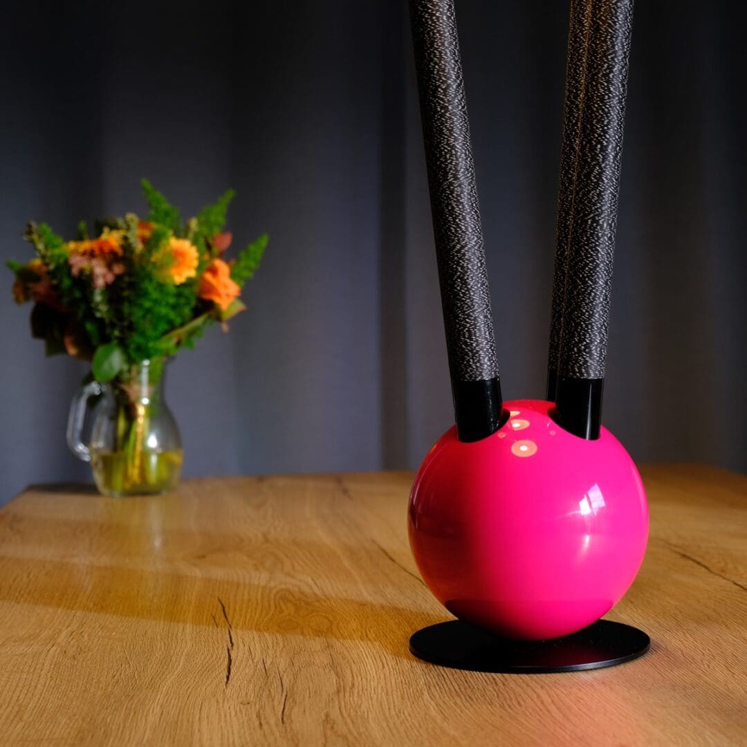 Pink orb lamp with black stems.
