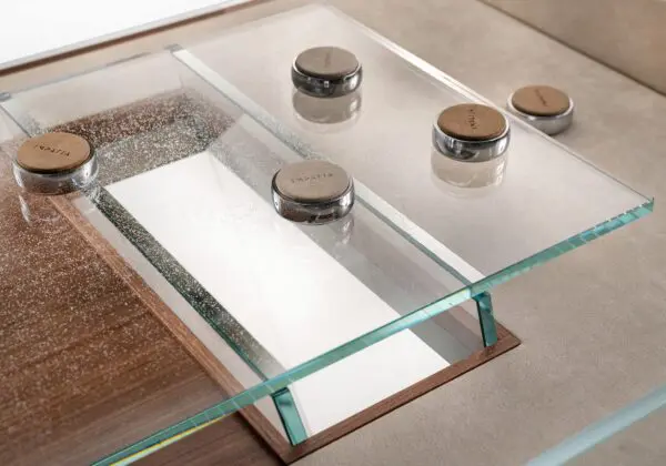 Glass top table with Impatia coasters.